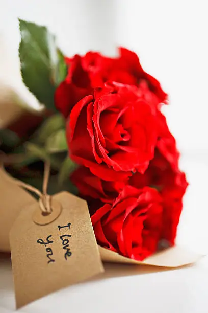 Photo of Close up of red roses with gift tag
