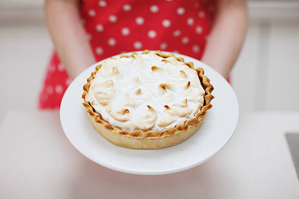 Woman holding lemon meringue pie  meringue stock pictures, royalty-free photos & images