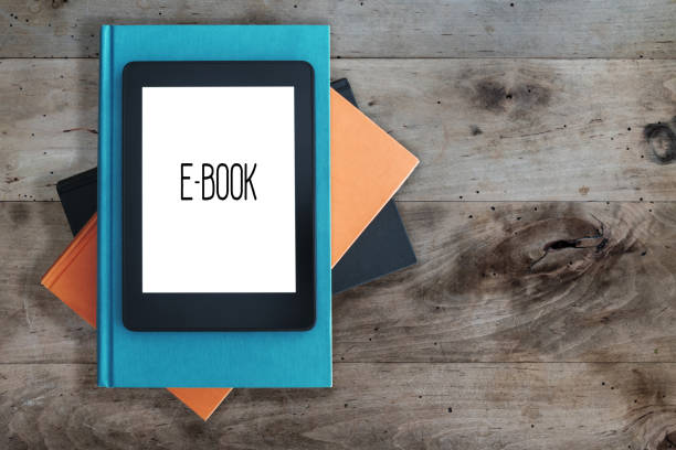 istock top view of e-book reader on a stack of books on rustic wooden table concept 1033346066