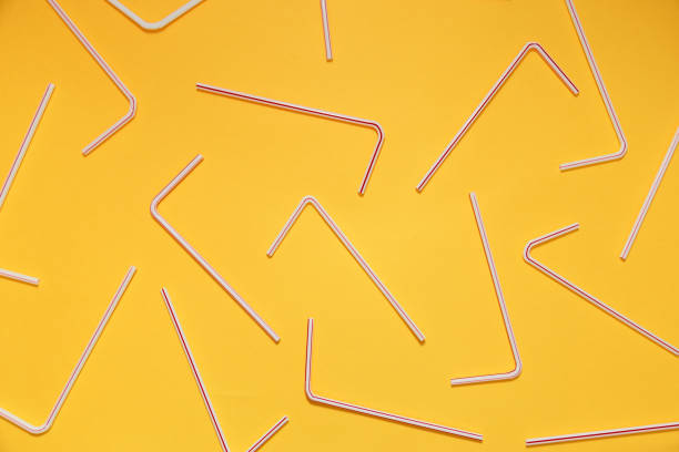 istock Drinking straws for party on yellow background. Top view 1033349018