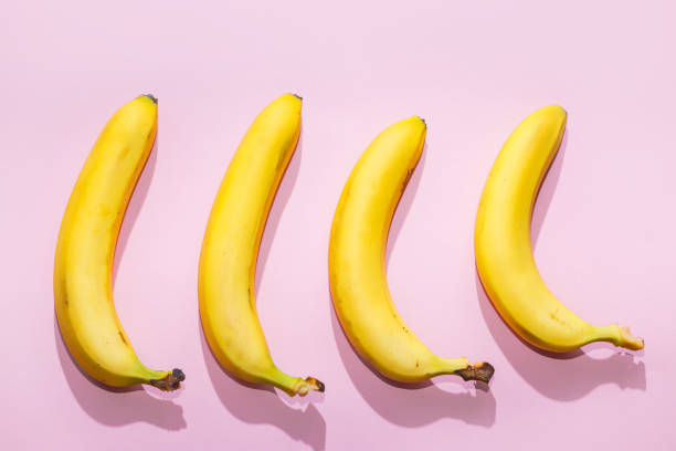 istock Bananas on pink pastel background. minimal idea food concept 1033353564
