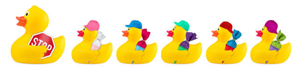 yellow classic rubber bath duck toy road safety yellow classic rubber bath duck toy road safety school crossing guard concept row isolated on white background ducks in a row concept stock pictures, royalty-free photos & images