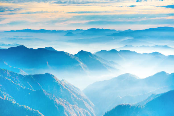 istock Landscape with sunset in blue mountains 1033358448
