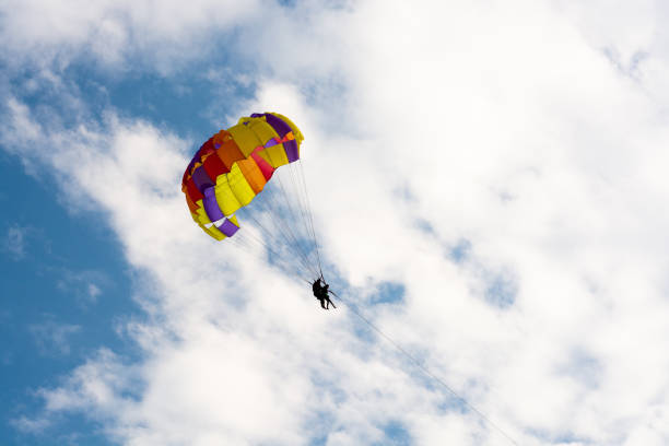 istock Parachute jumping. Parachute is in the sky, under the clouds. 1033359884