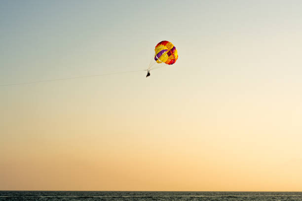 istock Parachute jumping. Parachute is in the sky, under the clouds. 1033362482