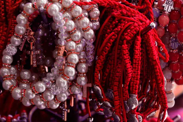 Photo of Bracelet braided from red thread and pearls. amulet against the evil eye on the wrist from Jerusalem, Israel