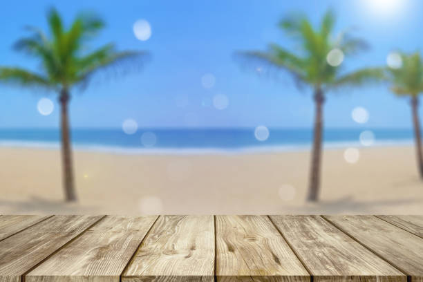 istock wooden table with blurred beach background 1033388878