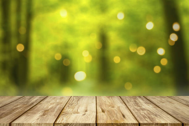wooden table with blurred summer forest background