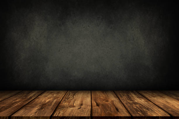 wooden table with grey wall background Old wooden table template with dark grey wall background. stage set stock pictures, royalty-free photos & images
