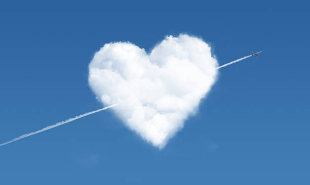 istock heart shaped cloud and airplane in the sky 2 1033389136