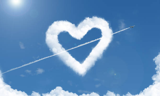 istock heart shaped cloud and airplane in the sky 3 1033391218