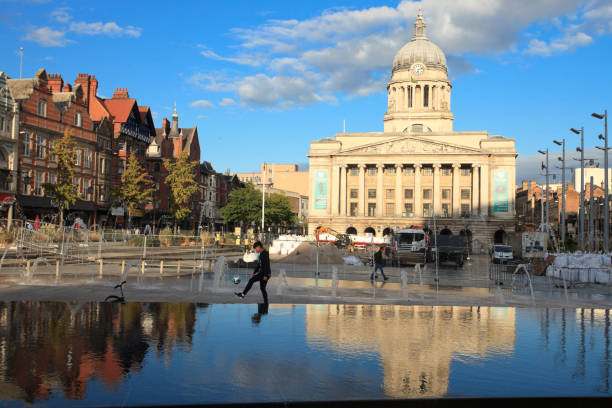 An african ethnicity boy is practicing with a ball on the Old Market Square in Nottingham, one of the oldest public squares in the UK with an 800 year history.