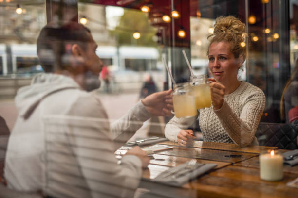 istock Young beautiful couple toasting in restaurant. 1033408306