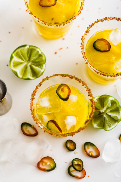 cocktail margarita of tequila, mango juice, hot pepper and lime on the table. bar accessories