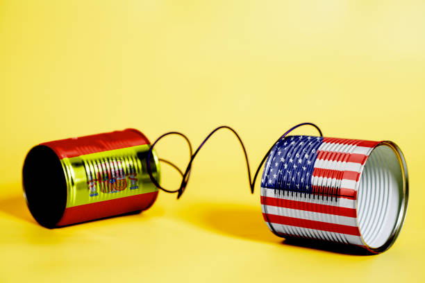 istock tin can phone with USA and Spain Flags. communication concept 1033417420