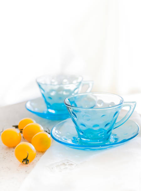 istock Blue coffee cups with yellow tomatoes 1033426338