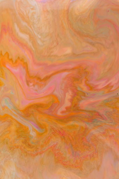 istock Fluid art. Abstract multicolored background on liquid. Orange spots of colors. Blurred pattern. Holographic texture 1033427250