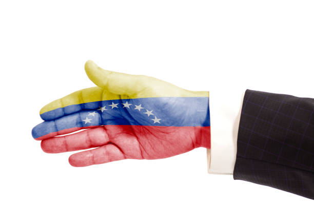 istock Handshake gesture businessman hand with Venezuela Flag 1033430232