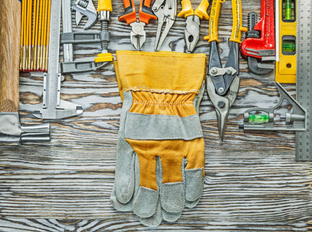 Heap of construction tooling on wooden board.