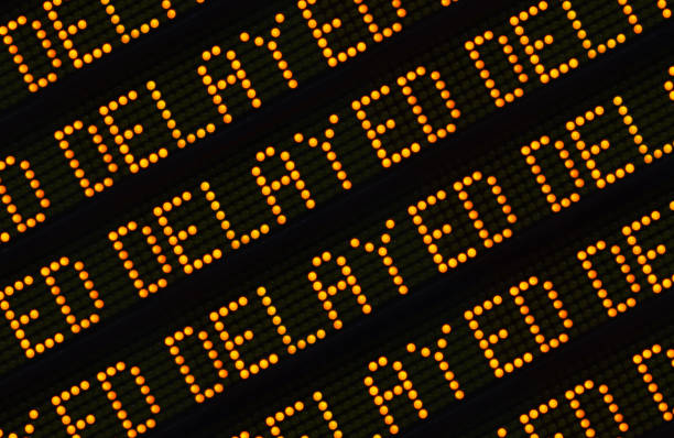 Delayed Sign Closeup A Close Up Of The Word Delayed Repeated Multiple Times On A Sign At A Station Or Airport delayed sign photos stock pictures, royalty-free photos & images
