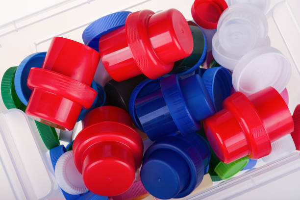 istock Colorful plastic lids in a box on white background 1033449724