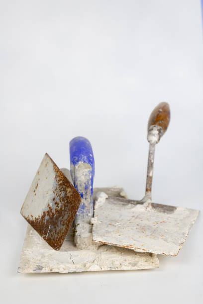 istock A dirty trowel on a white table. Tools for masons and construction workers. White background. 1033449818