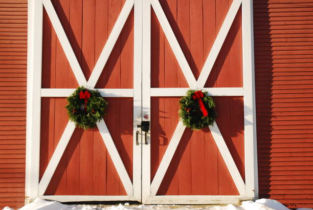 Chirstmas wreaths Christmas wreaths on a New England barn barn doors stock pictures, royalty-free photos & images