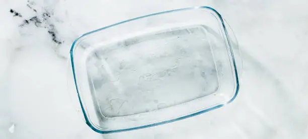 banner of Glass pan for baking on a marble table