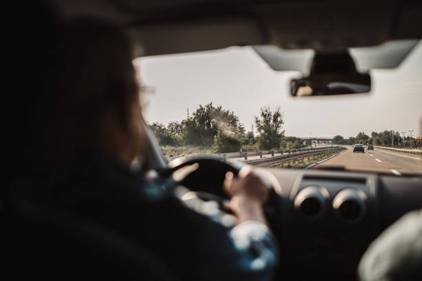 istock Experienced older man with glasses drives a car 1033508360
