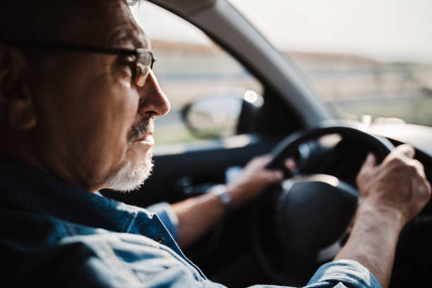 istock Senior Caucasian Man with Glasses and Beard Driving 1033510288