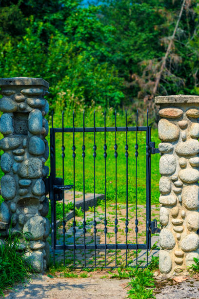 istock architectural element - wrought iron wicket and pillars trimmed with decorative stone 1033516006