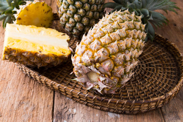 istock pineapple on the wood  background 1033516780