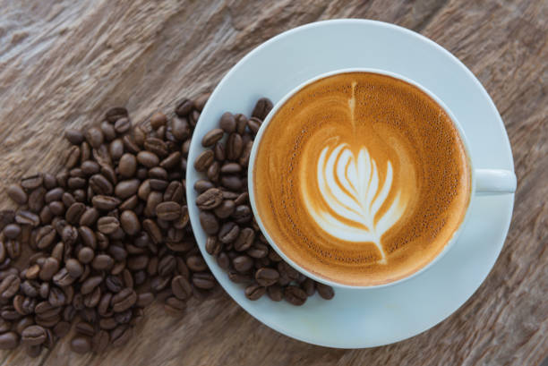 istock bean coffee with latte art or cappuccino on wooden table 1033520238