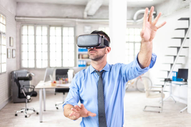 istock Businessman with VR headset in office 1033525908