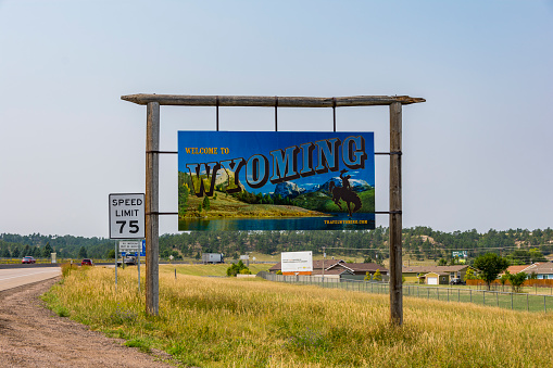 Pine Bluffs, Wyoming, United States - August 15, 2018: Shot of a Welcome Wyoming sign along the interstate I-80 in Pine Bluffs, WY.