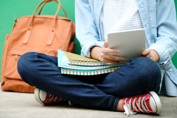 istock Student girl sitting and using digital tablet, online education, adult learning concept 1033552766