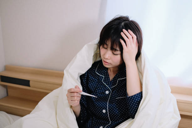 woman taking her own temperature