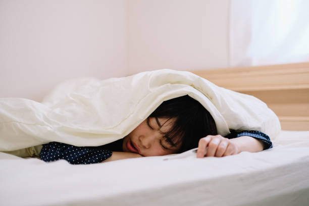 woman catching a cold is lying with thermometer in hand