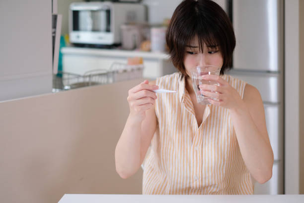 istock woman catching a cold and having fever 1033557452