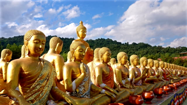 4k crane shot ;Public places, 1,250 Buddha statue, history of atmagha puja memorial buddhist park, Nakhon Nayok, Thailand