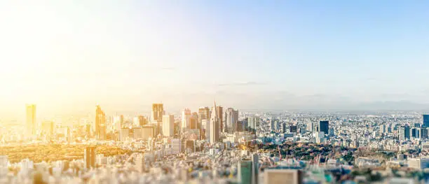 Business and culture concept - panoramic modern city skyline bird eye aerial view under dramatic blue sky in Tokyo, Japan. miniature lens tilt shift blur effect
