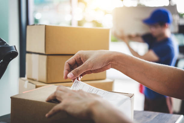 istock Home delivery service and working service mind, Woman working barcode scan to confirm sending customer in post office 1033598768