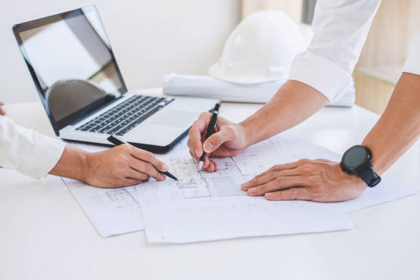 istock Architect or Engineer meeting working with partner on blueprint for architectural project in progress, construction and structure concept 1033605252