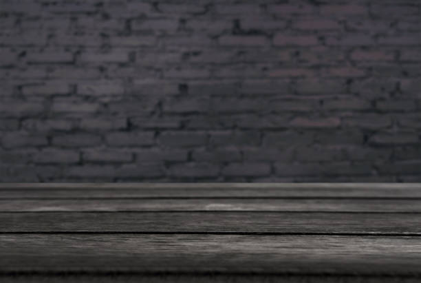 istock Selected focus empty black wooden table and wall texture or old black brick wall blur background image. for your photomontage or product display 1033605268
