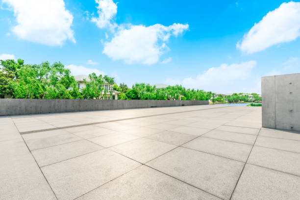 istock Empty city square and apartment buildings with green woods scenery 1033632806