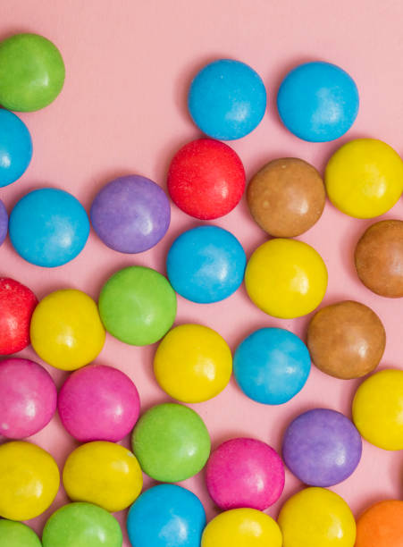 istock colorful bonbons on wooden table 1033632872