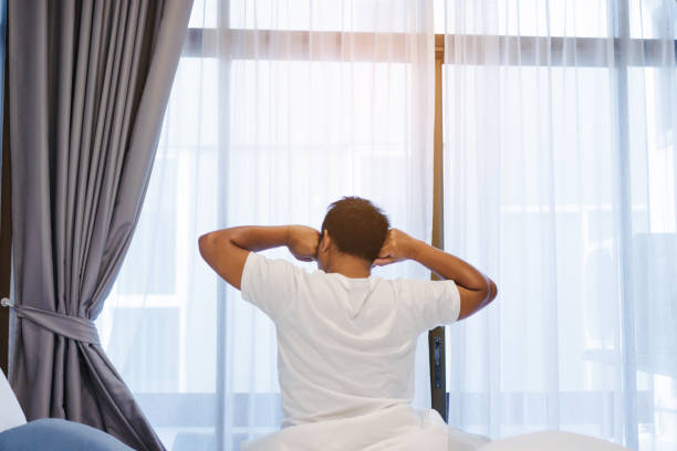 istock Man stretching in bed after wake up in the morning. 1033648228