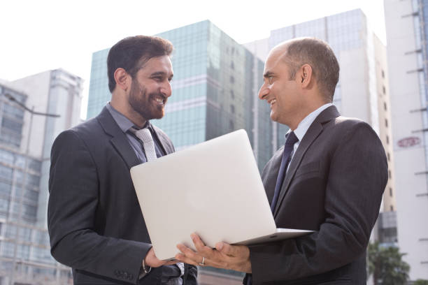istock Two businessmen with laptop in city 1033648832