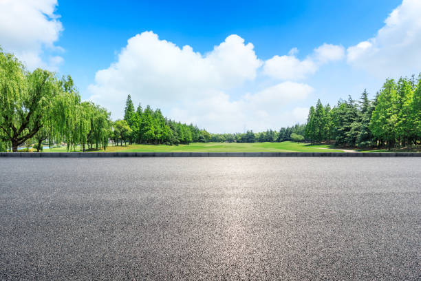 istock Empty asphalt road and green woods under blue sky 1033649082