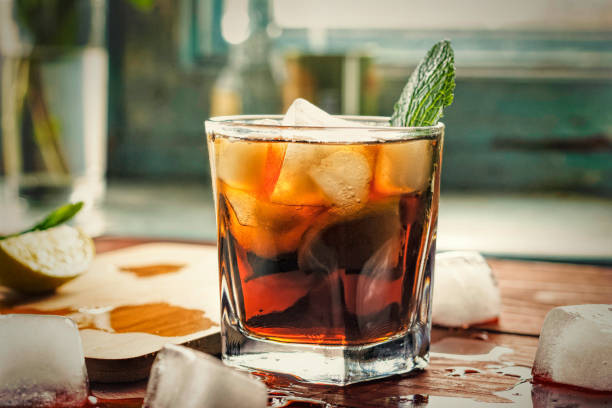alcohol, rum, Cuba Libre, cocktail, longdrink, strong drink, Glass of rum on the wooden background, Cuba Libre or long island iced tea cocktail with strong drinks, cola, rum photos stock pictures, royalty-free photos & images